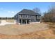 Beautiful two-story home with dark gray siding, a well-manicured lawn, and concrete driveway at 115 River Meadow Ln, Social Circle, GA 30025