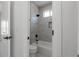 Well-lit bathroom features sleek fixtures, a modern tile surround, and a convenient built-in niche at 115 River Meadow Ln, Social Circle, GA 30025