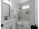 Bright bathroom features a shower-over-tub with tile surround, recessed niche and modern vanity at 115 River Meadow Ln, Social Circle, GA 30025