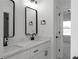 Modern bath with double marble-top sinks, black hardware, and decorative mirrors at 115 River Meadow Ln, Social Circle, GA 30025
