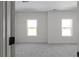 Bright bedroom featuring neutral paint, plush carpeting, and double windows at 115 River Meadow Ln, Social Circle, GA 30025