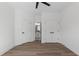 Bedroom with wood-look flooring, ceiling fan, double closets, and ensuite bathroom at 115 River Meadow Ln, Social Circle, GA 30025