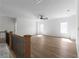 Large bonus room with wood-look flooring, ceiling fan, and plenty of natural light at 115 River Meadow Ln, Social Circle, GA 30025