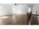 Large bonus room with wood-look flooring, ceiling fan, and plenty of natural light at 115 River Meadow Ln, Social Circle, GA 30025