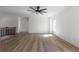 Large bonus room with wood-look flooring, ceiling fan, and plenty of natural light at 115 River Meadow Ln, Social Circle, GA 30025