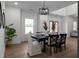 Open dining space featuring a modern table setting, decor, wood floors, and a bright atmosphere at 115 River Meadow Ln, Social Circle, GA 30025
