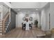Elegant dining area with modern chandelier, wood floors, and decorative wall paneling at 115 River Meadow Ln, Social Circle, GA 30025