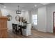 Bright dining room with a modern chandelier, table setting, and wood floors at 115 River Meadow Ln, Social Circle, GA 30025