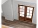View from the second floor overlooking the entryway's double wooden doors and wood flooring at 115 River Meadow Ln, Social Circle, GA 30025