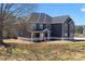 Well-maintained two-story home with dark gray siding and an inviting entrance at 115 River Meadow Ln, Social Circle, GA 30025