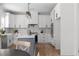 Contemporary kitchen featuring white cabinetry, navy island and stone countertops at 115 River Meadow Ln, Social Circle, GA 30025
