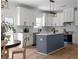 Modern kitchen with white cabinets, navy island, and stainless steel appliances at 115 River Meadow Ln, Social Circle, GA 30025