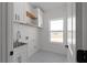 Clean laundry room with white cabinets and a window at 115 River Meadow Ln, Social Circle, GA 30025