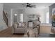 Well-lit living room with neutral furniture and direct access to staircase and other rooms at 115 River Meadow Ln, Social Circle, GA 30025