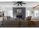 Comfortable living room with fireplace, neutral furniture, and a ceiling fan at 115 River Meadow Ln, Social Circle, GA 30025