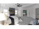 Light-filled main bedroom featuring a cozy fireplace, and an open doorway to the ensuite bathroom at 115 River Meadow Ln, Social Circle, GA 30025