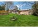 Expansive backyard featuring lush green lawn, a bird bath, and a screened-in porch on a stone house at 1198 Seminary Dr, Marietta, GA 30064