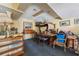 Basement interior featuring a carpet, an old wooden table surrounded by wooden chairs, and items for storage at 1198 Seminary Dr, Marietta, GA 30064