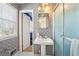 Vintage bathroom featuring patterned wallpaper, a pedestal sink, and a window that provides natural light at 1198 Seminary Dr, Marietta, GA 30064