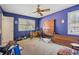 Bedroom painted blue with a ceiling fan and a window at 1198 Seminary Dr, Marietta, GA 30064