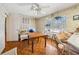 Dining room with floral wallpaper, wood floors, table, ceiling fan, and natural light at 1198 Seminary Dr, Marietta, GA 30064