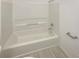 Bright bathroom featuring a clean, white tub and shower combination with modern fixtures at 474 Berckman Nw Dr, Lilburn, GA 30047