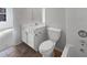 Bright bathroom featuring a white vanity, a toilet, and a combination shower/tub at 474 Berckman Nw Dr, Lilburn, GA 30047