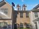 A brick townhome featuring a black front door and dormer windows at 474 Berckman Nw Dr, Lilburn, GA 30047