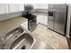 Bright kitchen features stainless steel appliances, tile flooring, and neutral countertops at 474 Berckman Nw Dr, Lilburn, GA 30047