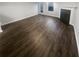 Open living room boasts hardwood floors, a fireplace, and natural light at 474 Berckman Nw Dr, Lilburn, GA 30047