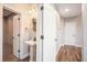 Bathroom featuring pedestal sink, wall mirror, wood look flooring and white paneled doors at 8955 Shalford Ct, Cumming, GA 30041