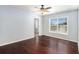 Bedroom with hardwood floors, a ceiling fan, and a large window offering ample natural light at 8955 Shalford Ct, Cumming, GA 30041