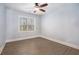 Comfortable bedroom with wood-look floors and large windows, offering natural light and a peaceful atmosphere at 8955 Shalford Ct, Cumming, GA 30041