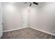 Carpeted bedroom featuring white trim, ceiling fan and white paneled door leading to hall at 8955 Shalford Ct, Cumming, GA 30041