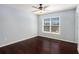 Bedroom with hardwood flooring, a large window offering ample natural light, and a ceiling fan at 8955 Shalford Ct, Cumming, GA 30041