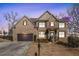 Charming two-story brick home with a two-car garage and manicured lawn at 8955 Shalford Ct, Cumming, GA 30041