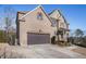Beautiful brick home featuring a two-car garage and attractive landscaping, showcasing suburban living at 8955 Shalford Ct, Cumming, GA 30041