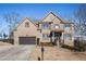 Charming two-story brick home with a two-car garage and well-maintained landscaping on a sunny day at 8955 Shalford Ct, Cumming, GA 30041