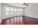 Spacious living room with hardwood flooring, recessed lights, and large windows offering lots of natural light at 8955 Shalford Ct, Cumming, GA 30041
