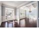 Elegant living room with hardwood floors, coffered ceiling, and large windows, offering natural light at 8955 Shalford Ct, Cumming, GA 30041
