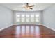 Open living room area with hardwood flooring, recessed lighting, and large windows overlooking a lush landscape at 8955 Shalford Ct, Cumming, GA 30041
