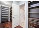 Spacious walk-in closet with custom shelving and wood flooring, providing ample storage at 8955 Shalford Ct, Cumming, GA 30041