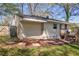 Spacious backyard featuring a small wooden deck, grass, and mature trees at 3351 Phillip Cir, Decatur, GA 30032