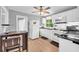 Efficient kitchen featuring white appliances, black countertops, and a casual dining area at 3351 Phillip Cir, Decatur, GA 30032