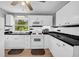 Well-lit kitchen with sleek white cabinets, stainless steel appliances, and hardwood-style floors at 3351 Phillip Cir, Decatur, GA 30032