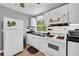 Bright kitchen featuring white appliances, black countertops, and ample storage space at 3351 Phillip Cir, Decatur, GA 30032