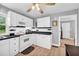 Clean kitchen featuring white cabinetry, black countertops and backsplash, and modern appliances at 3351 Phillip Cir, Decatur, GA 30032