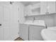 Functional laundry room with washer, dryer, storage cabinets, and sink at 3351 Phillip Cir, Decatur, GA 30032