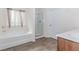 Bathroom featuring soaking tub, enclosed shower and white cabinets at 3391 Meadow Grass Dr, Dacula, GA 30019
