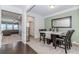 Elegant dining room featuring modern decor, a stylish table, and plush carpeting at 3391 Meadow Grass Dr, Dacula, GA 30019